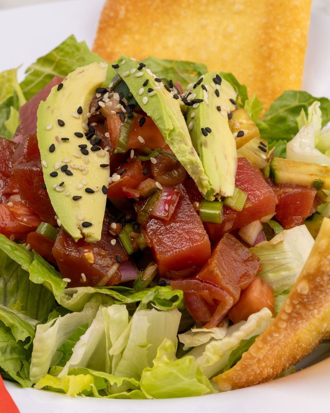 Tuna poke with avocado over crisp lettuce