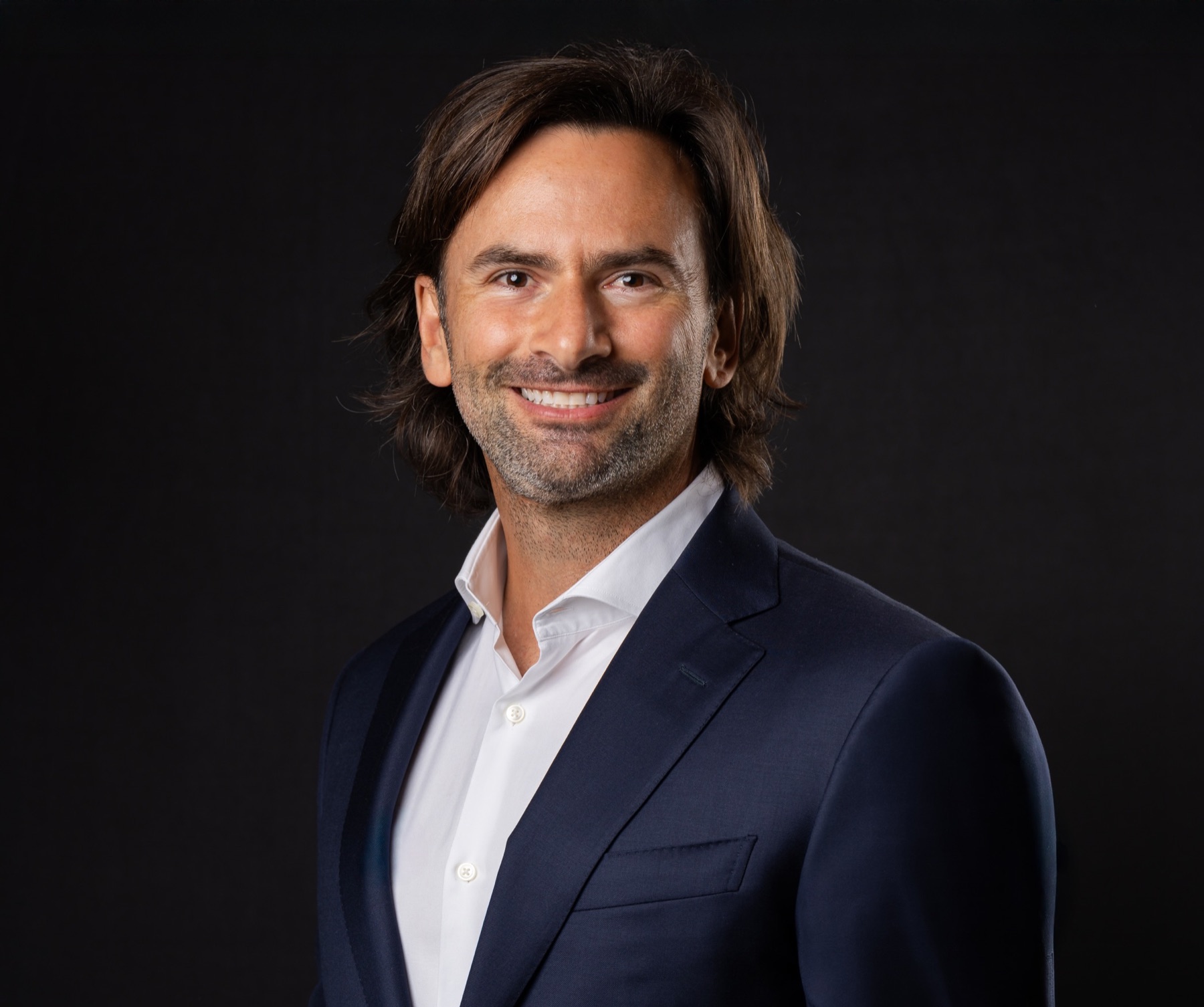 Professional headshot in a dark suit