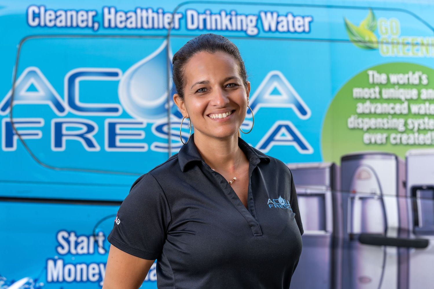 An Acqua Fresca team member in front of the company van, photographed on location